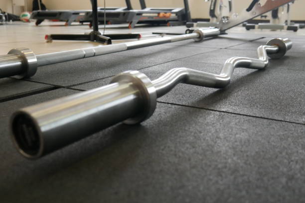 istock Low-Angle Close-Up of Curl Barbell with Bokeh Effect 2182211447