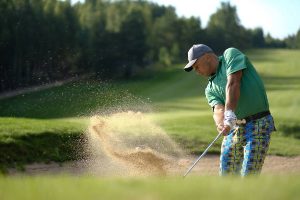 istock Golfer hits ball from a bunker with golf club concept 2182214039