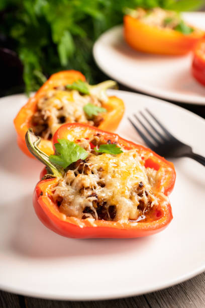 istock Stuffed peppers with herbs and cheese on the rustic background 2182216330