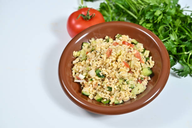 istock a small brown bowl filled with rice next to some veggies 2182219192