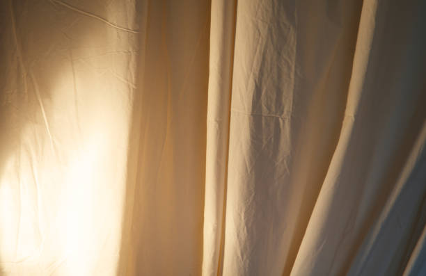 istock A white curtain is hanging in front of a light 2182222762