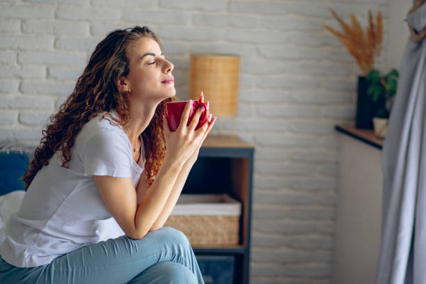 istock Woman drinking coffee in bed in the morning 2182223229