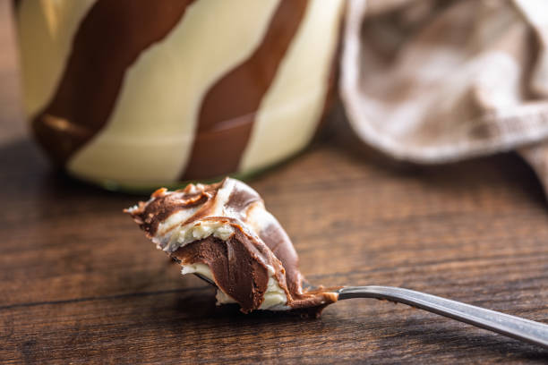 istock Chocolate cream spread in spoon on wooden table. 2182224370