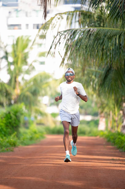 istock Focused Athlete Running Outdoors on a Sunny Day 2182225638