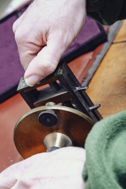 istock Watch repairer adjusts tool, demonstrating refined expertise 2182226380