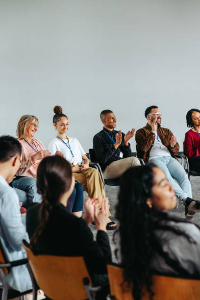 istock Corporate team participating in a workshop, diverse group applauding and showcasing collaboration and engagement 2182229164