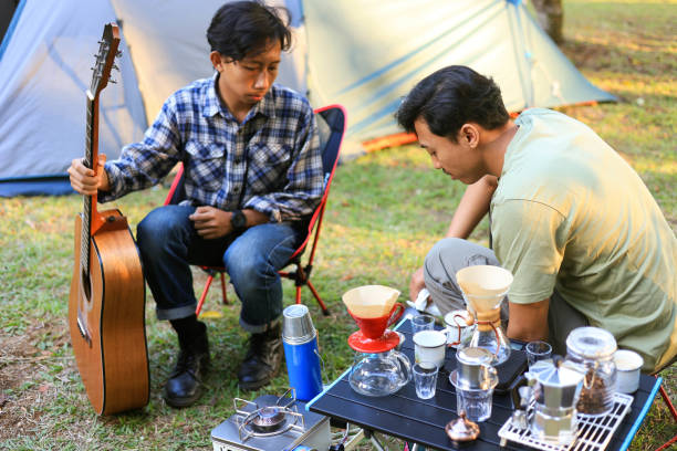 istock Two Young People Making Coffee at Camping Ground 2182231048