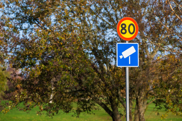 Speed camera sign by the side of a road.
