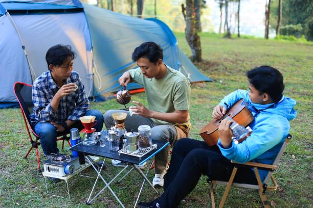 istock Three Young Male Asian People Making Coffee at Camping Ground 2182232810