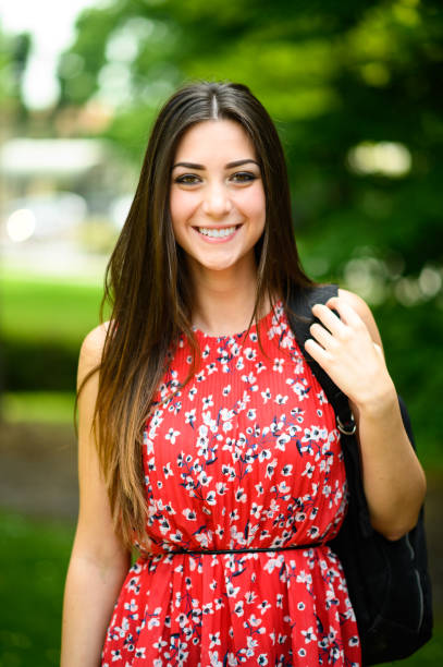 istock Young student smiling at the camera in a park 2182240075