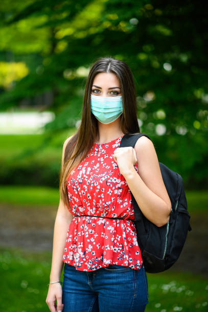 istock Young student wearing protective face mask going to school 2182240943