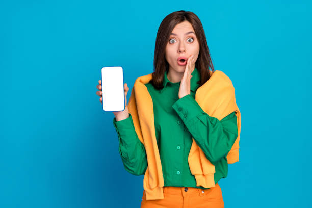 istock Portrait of impressed crazy lady arm touch cheek pouted lips empty space telephone display isolated on blue color background 2182241217