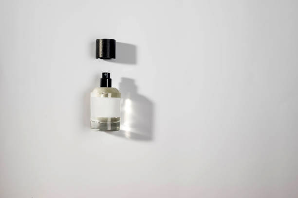 Madrid. Spain. Businessman reaching for a luxurious bottle of perfume, preparing for a stylish day at work while enhancing his morning grooming routine