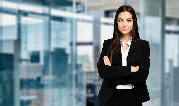 istock Confident businesswoman smiling with folded arms in office 2182242321