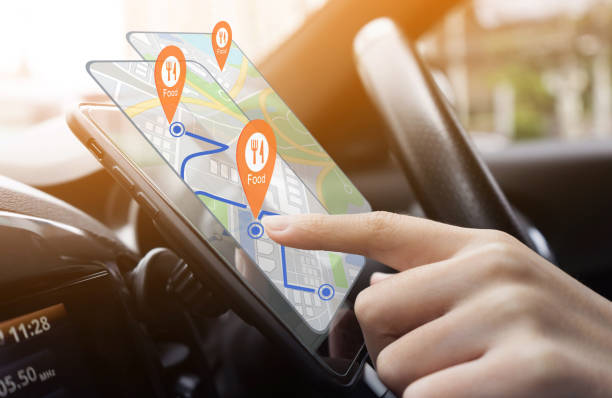 Person using  GPS navigation app on a smartphone in a car, with food location pins displayed on the screen. Ideal for concepts of technology in travel, food delivery