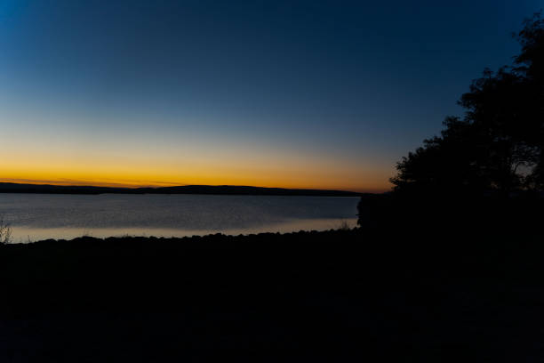 istock blue hour, orange and blue sky in transition 2182243142