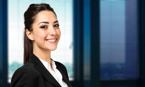 istock Young businesswoman smiling in modern office 2182243914