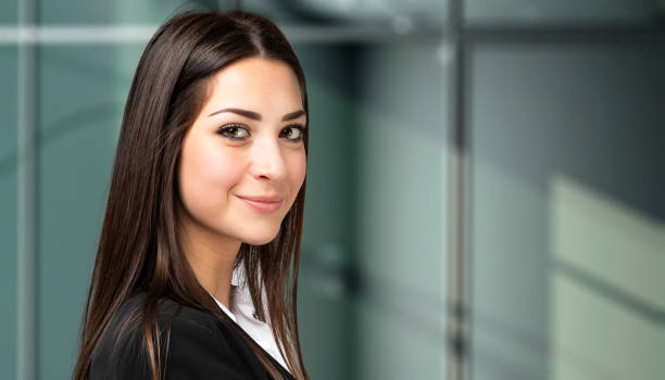 istock Young businesswoman smiling in modern office building 2182244111
