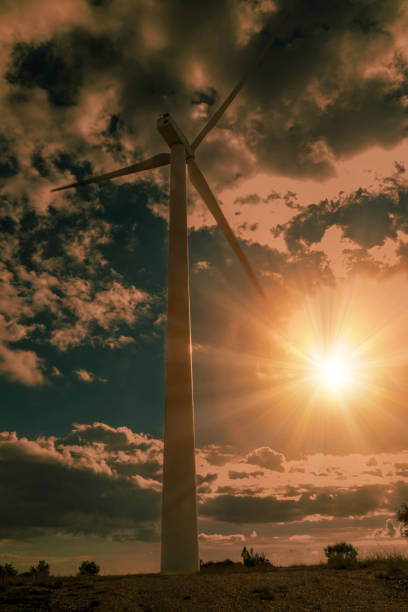 Powerful wind turbine generating clean energy against a dramatic sunset sky, symbolizing sustainable power and a greener future