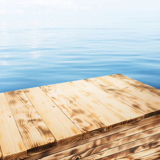Beautiful pine wood texture table top with burn fire wood surface on blue sea water or swimming pool.For decoration product display placement background.