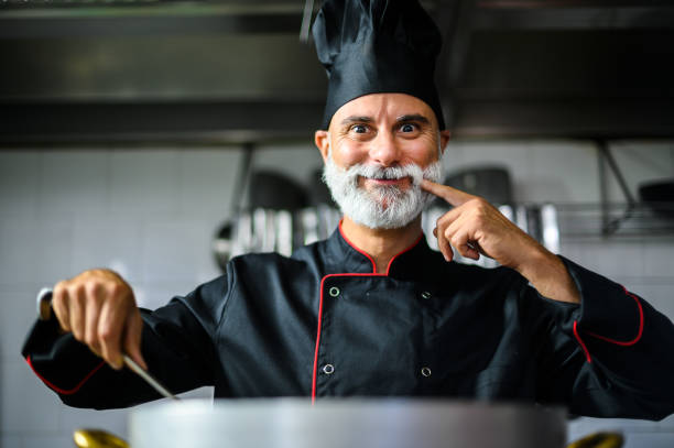 istock Professional chef tasting food in a commercial kitchen: 2182246500