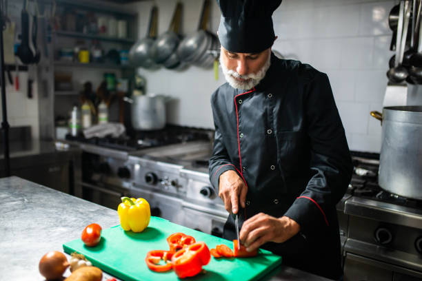 istock Professional chef cutting fresh vegetables in a commercial kitchen 2182246553