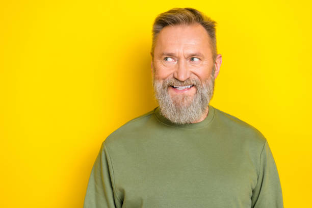 istock Photo of dreamy handsome man pensioner dressed green pullover looking empty space isolated yellow color background 2182247212