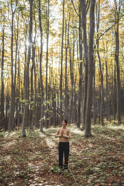 istock Woman stands in the forest and meditates 2182247536