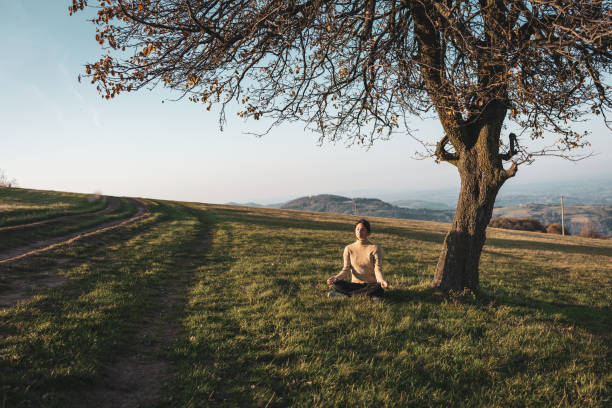 Woman enjoying day in the nature, she is meditating