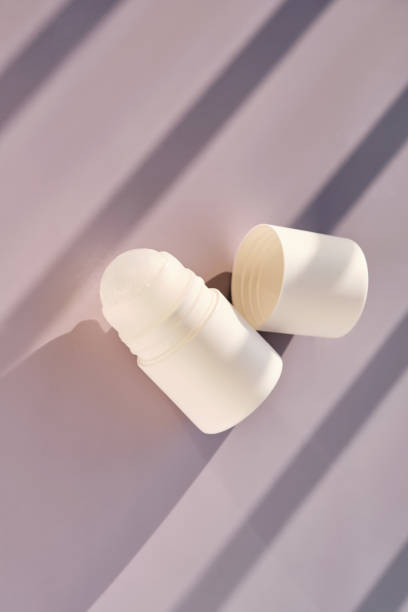 istock Roll-on deodorant on a purple background with shadow stripes. 2182248518