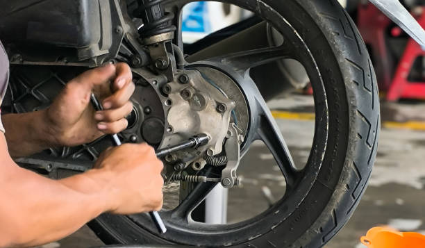 istock A technician is unscrewing a motorbike bolt using a wrench 2182249695