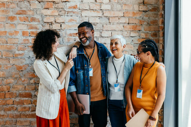istock Coworkers laughing and sharing joyful moments in a modern office setting during a casual break 2182250700