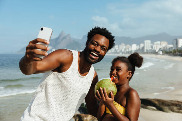 istock Father and daughter taking a selfie on a sunny beach day 2182251055