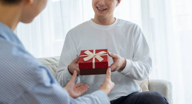 istock Men and women giving gifts 2182251237