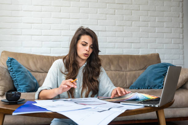 istock Side hustle. Young architecture and urbanism university student woman freelance work as side job as interior designer working at home with client using laptop computer for communication and video call 2182252599