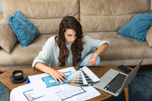 istock Side hustle. Young architecture and urbanism university student woman freelance work as side job as interior designer working at home with client using laptop computer for communication and video call 2182252618