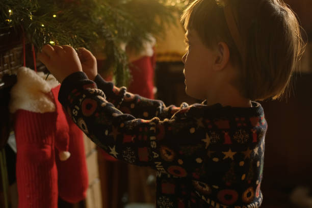 istock Child decorates cozy home for Christmas holidays 2182252982
