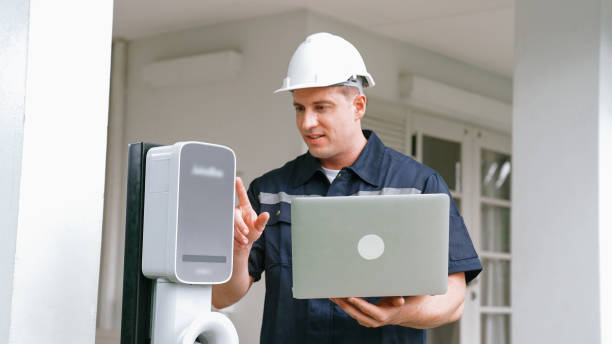 istock Qualified technician working with laptop for home EV station. Synchronos 2182253895