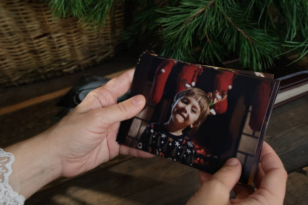 istock Female Hands Holding Printed Christmas Photos 2182254071
