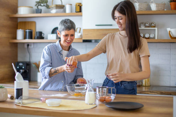 istock Mother and Daughter making pizza dough in the kitchen 2182254496