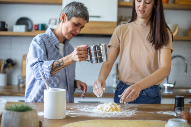istock Mother and daughter baking cookies 2182254653