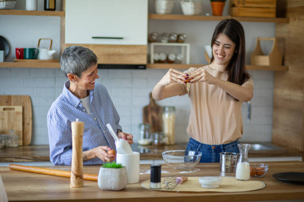 istock Mother teaches daughter how to make cakes 2182254974