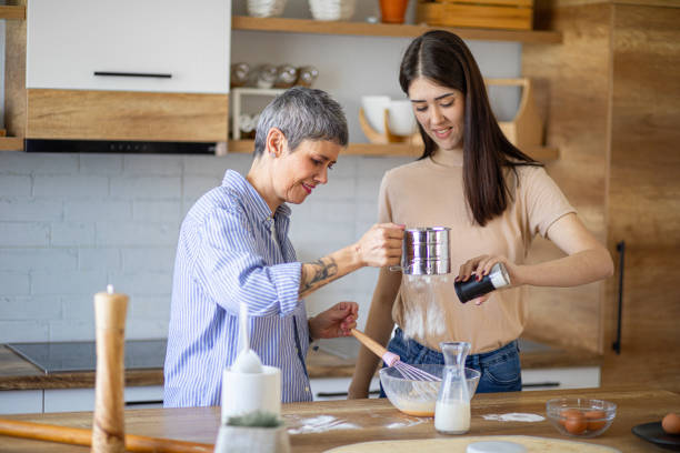 istock Mother teaches daughter how to make cakes 2182255118