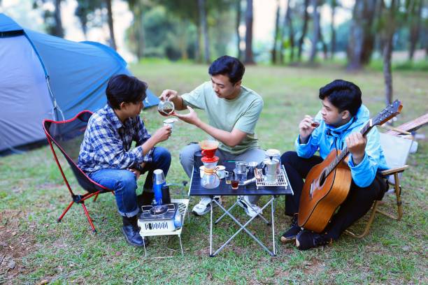 istock Three Young Male Asian People Making Coffee at Camping Ground 2182258381