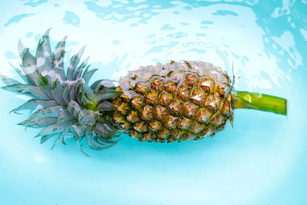 istock Ripe pineapple cut, Fresh fruit in blue water 2182259218