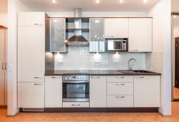 istock Scandinavian Style Cozy Modern Open Bright Kitchen Home Interior. Faucet, Fridge, Microwave, Stove, Oven, Cooker Hood and Furniture in Background. 2182260788