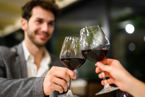 istock Couple toasting with red wine glasses in a restaurant 2182260906