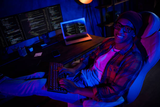 istock Photo of positive trader guy sit chair keyboard typing optimization microsoft late evening inside 2182261154
