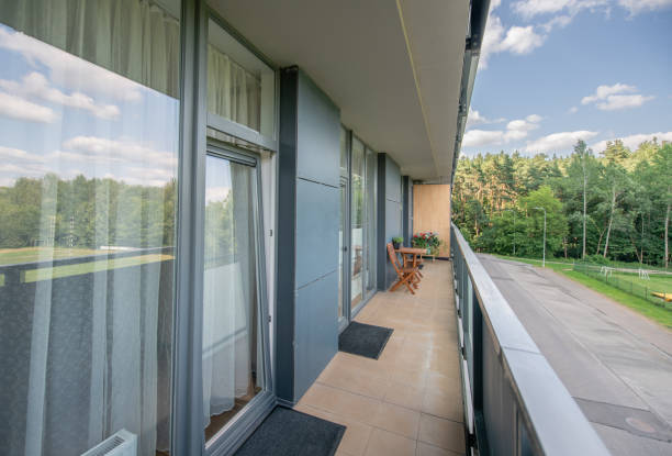 istock Chill Area and a Home Balcony Interior. Tiled Walls and Floor. Whitee Ceiling. Bright Suy Day, Cloudy Sky 2182261194