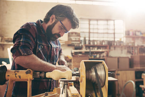 istock Closeup of a carpenter doing wood turning in his workshop 2182261276